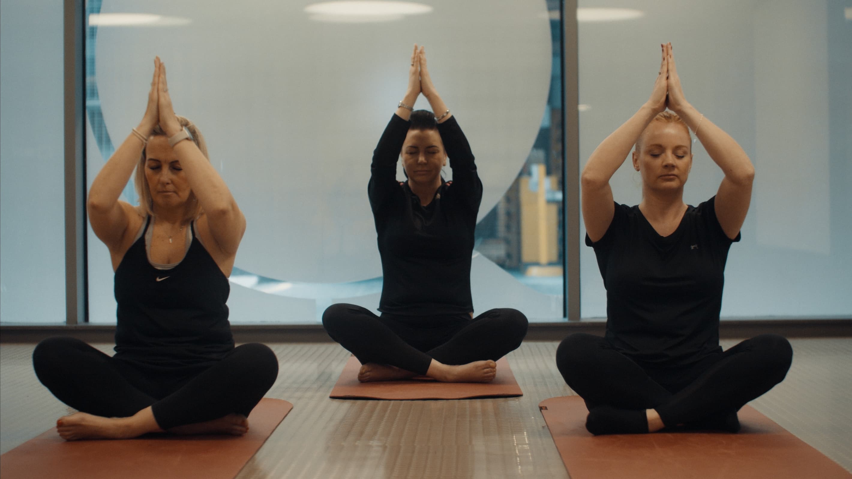 Three colleagues doing yoga